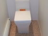 kohler_reve_elongated_one-piece_toilet_with_dual_flush_technology_on_recycled_cork_floor